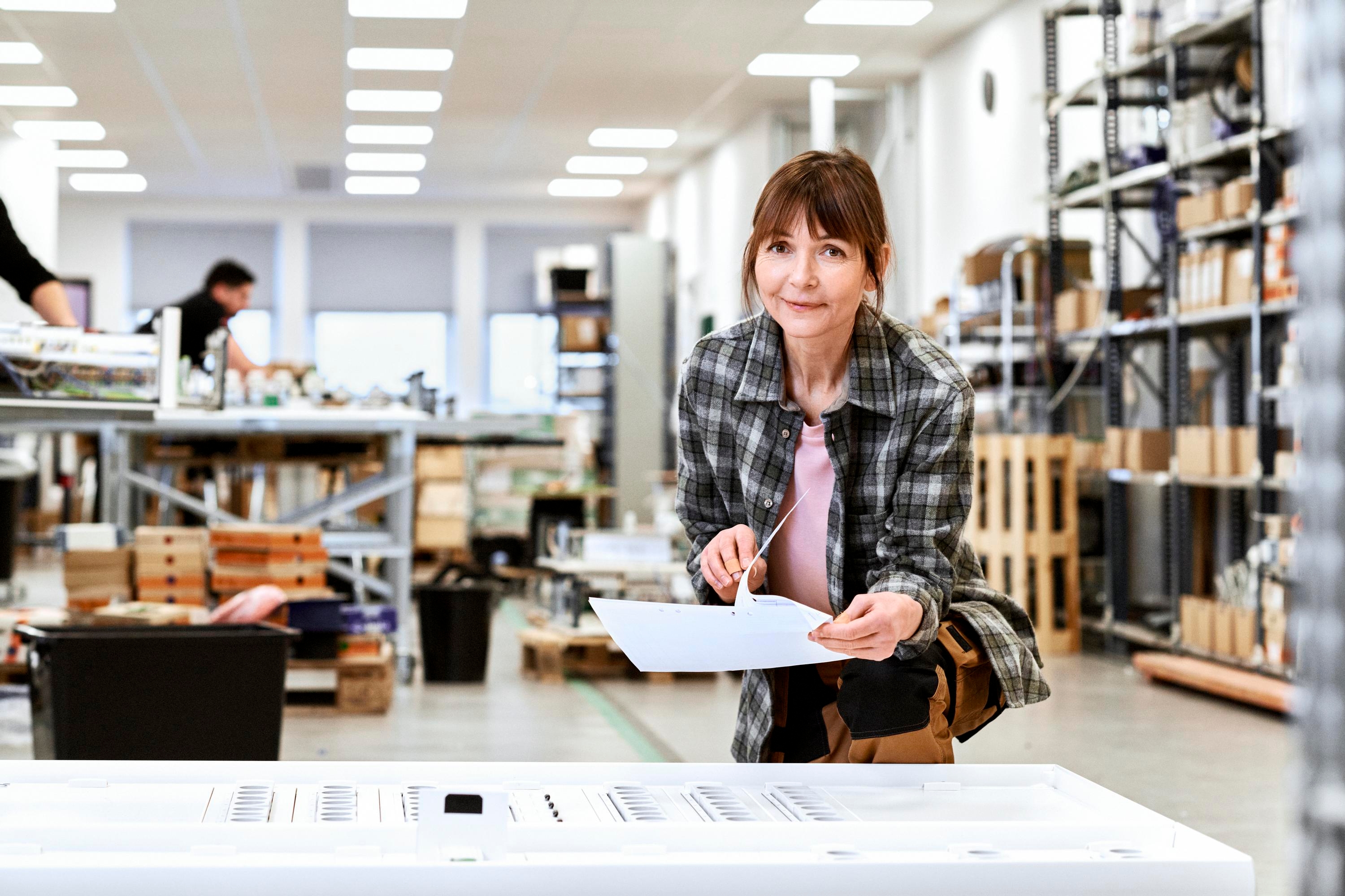 Woman flipping through a sheet of paper